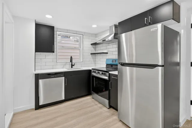 a kitchen with stainless steel appliances a refrigerator sink and stove