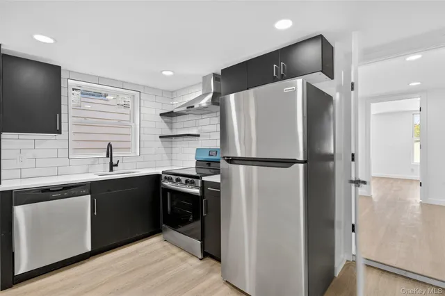 a kitchen with a refrigerator and a sink