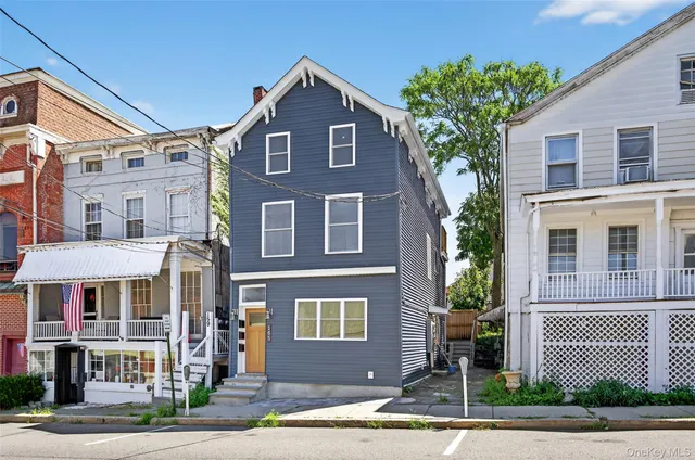 a front view of a residential houses with yard