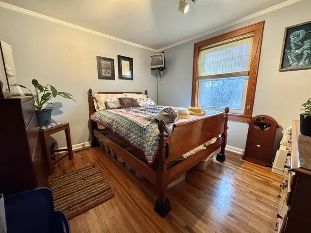 a bed room with a bed and a chair