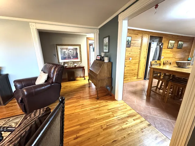 a living room with furniture fireplace and wooden floor