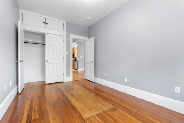 a view of an empty room and wooden floor