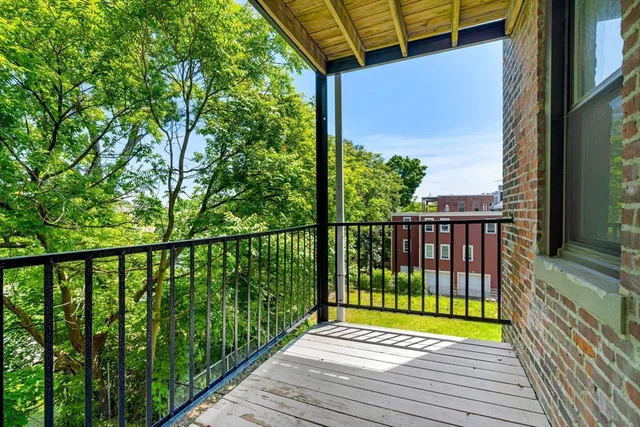 a view of a balcony with wooden floor