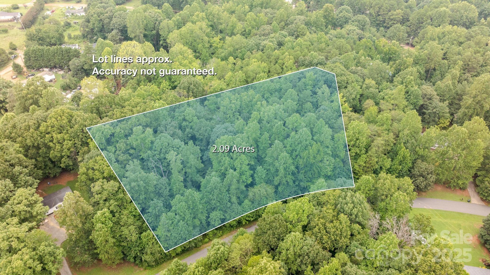 256 Sailwinds Road Mooresville, NC 28115 - Photo 2 of 8 a view of a green yard with large trees