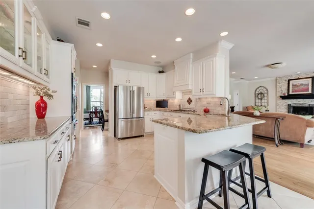 a bathroom with a granite countertop sink a toilet and a shower