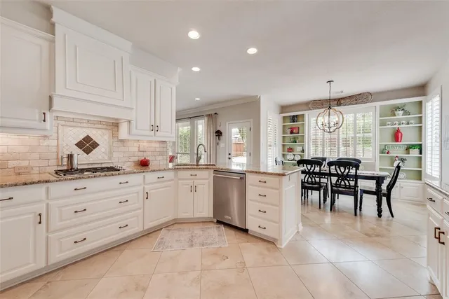 a spacious bedroom with a bed a window and a chandelier