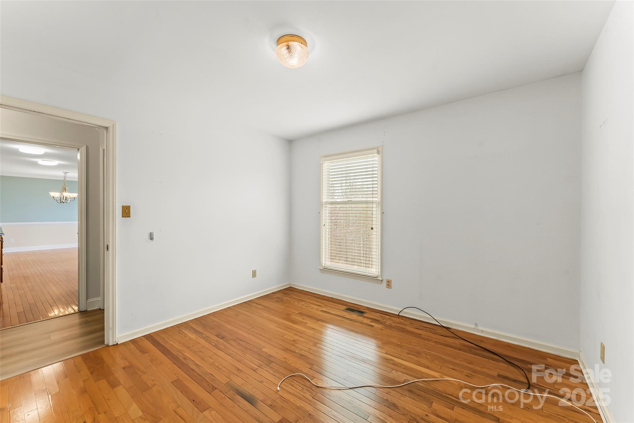 3772 Sandy Ford Road Hickory, NC 28602 - Photo 15 of 32 an empty room with wooden floor and windows