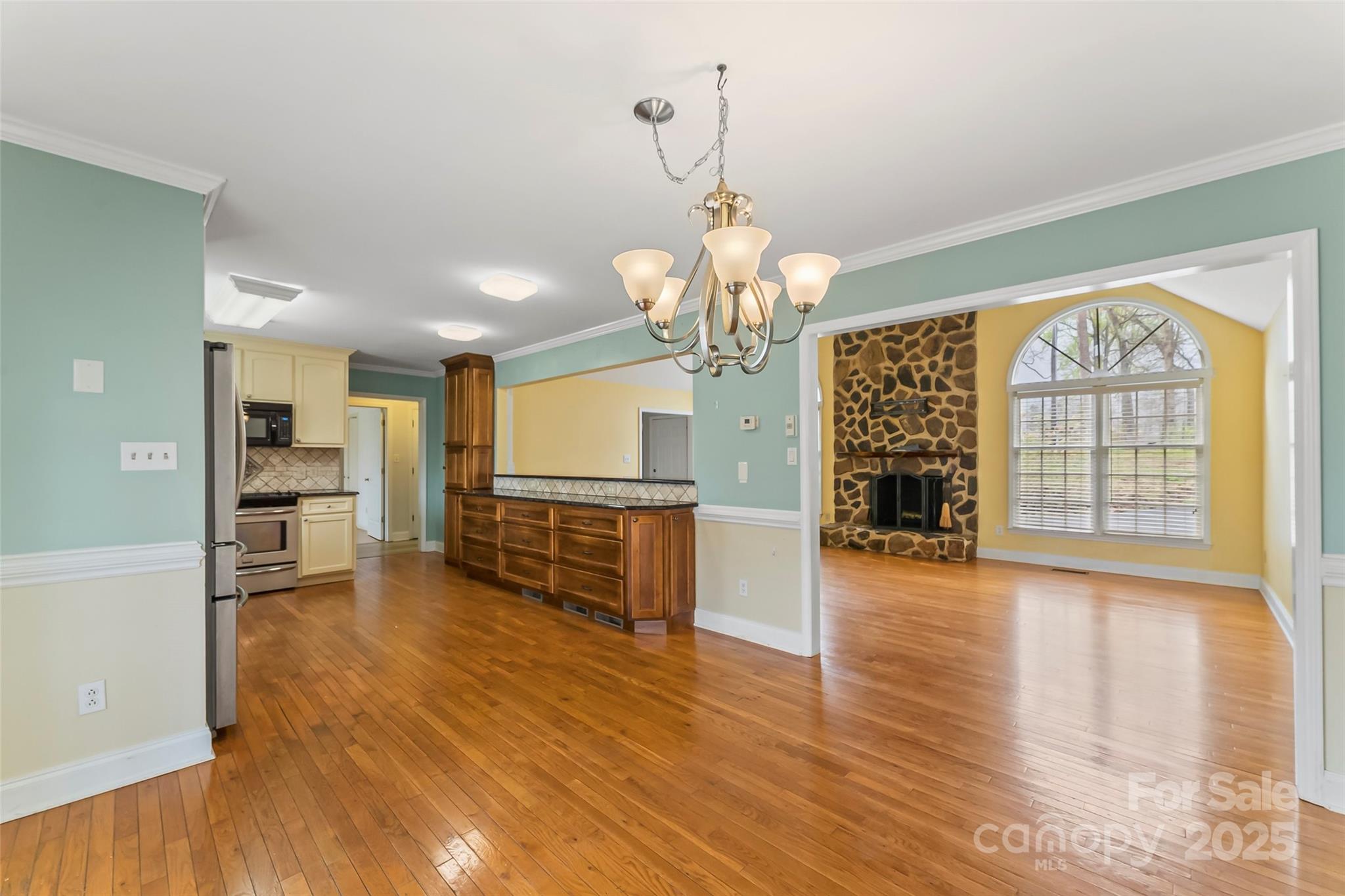 3772 Sandy Ford Road Hickory, NC 28602 - Photo 8 of 32 a view of a room with wooden floor chandelier and windows