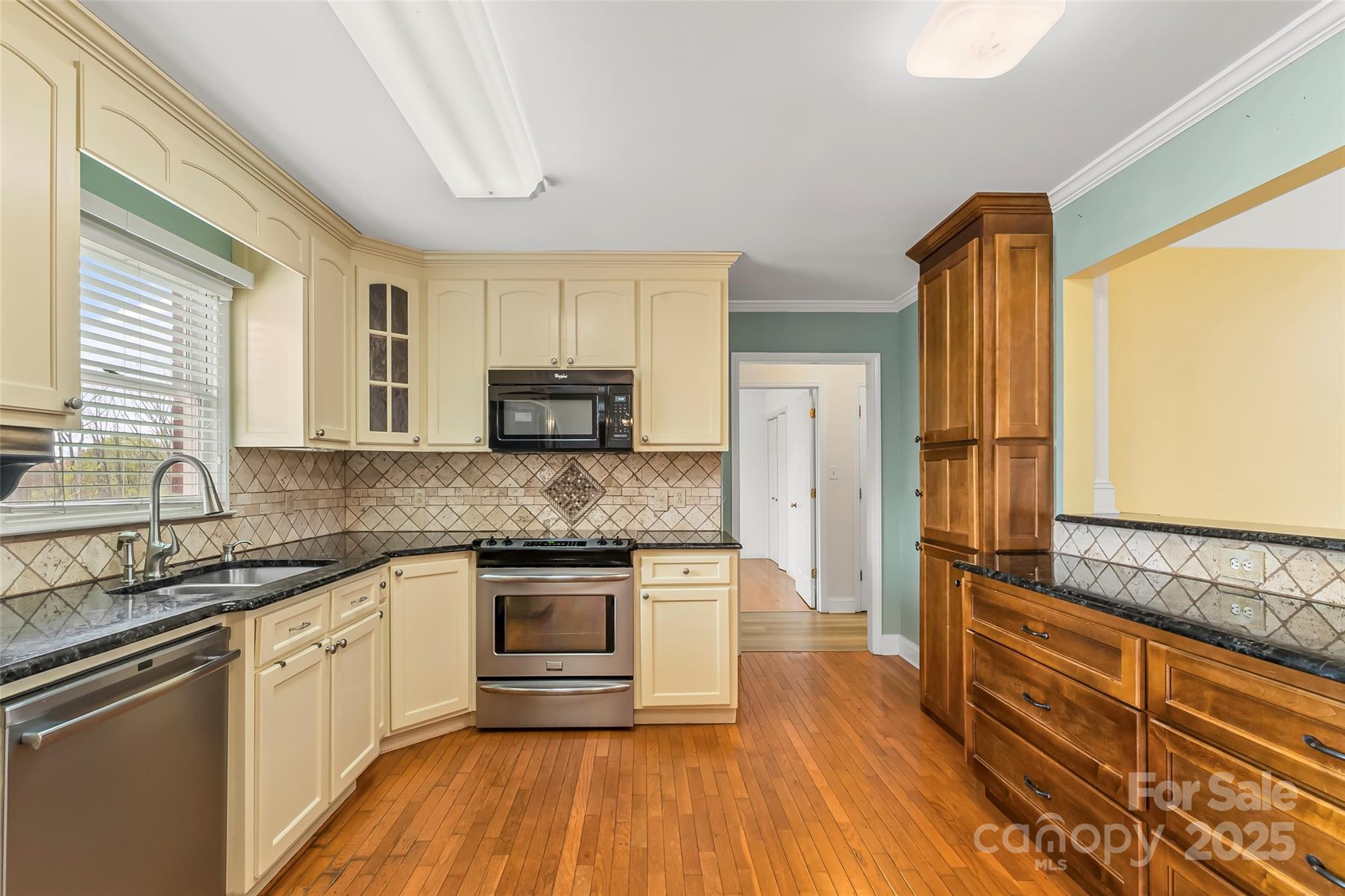 3772 Sandy Ford Road Hickory, NC 28602 - Photo 9 of 32 a kitchen with stainless steel appliances granite countertop wooden cabinets and a refrigerator