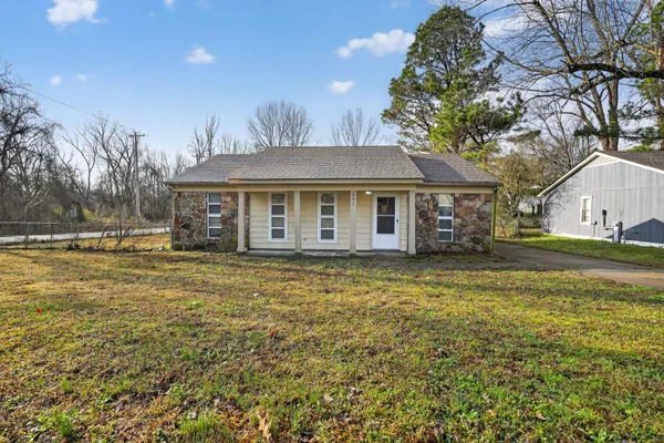 a front view of a house with a garden