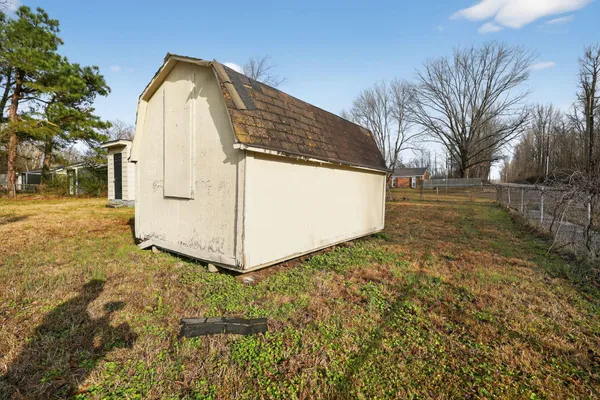 a view of a wooden house with a yard