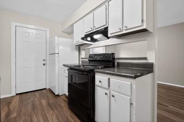 a kitchen with stainless steel appliances granite countertop a stove and a refrigerator