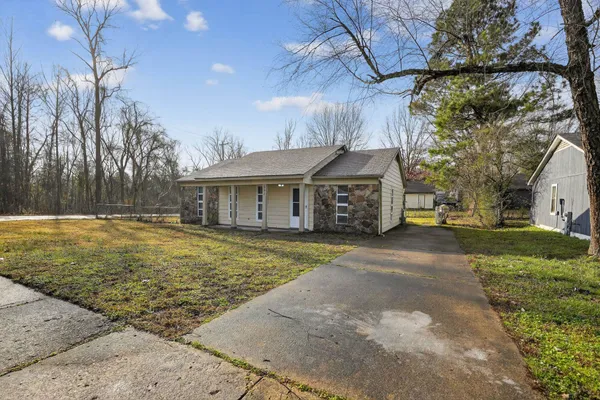a front view of house with a garden