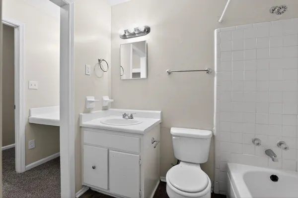 a bathroom with a toilet sink shower and mirror