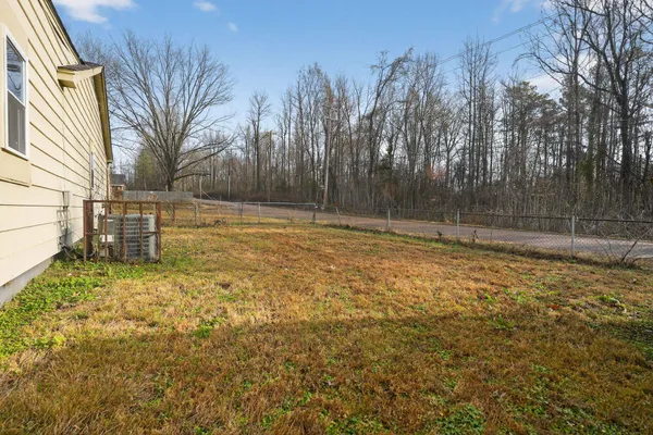 a view of a backyard with large trees