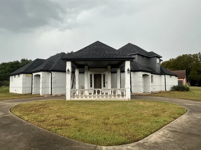 a front view of a house with garden