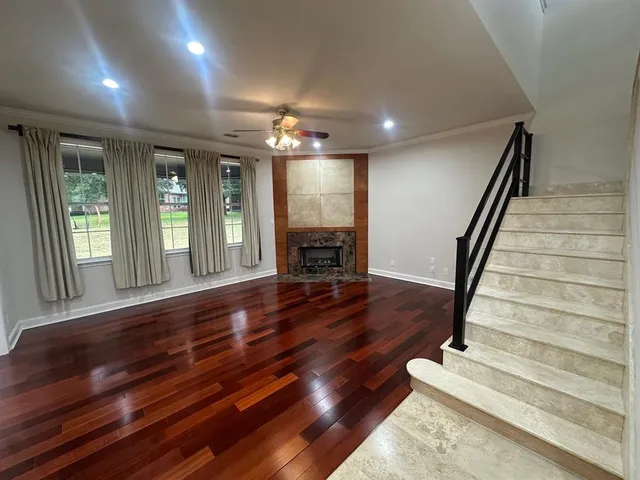 wooden floor in an empty room with a window