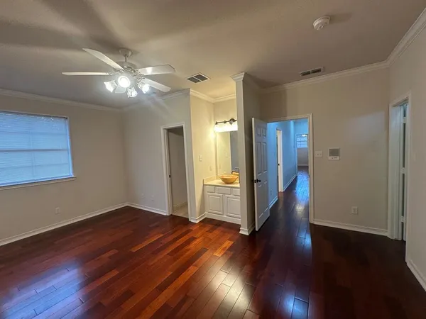 a view of empty room with wooden floor