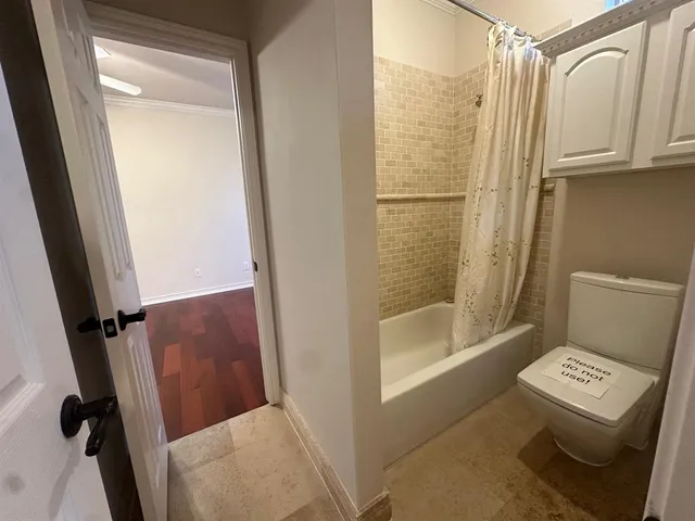 a bathroom with a shower and a toilet