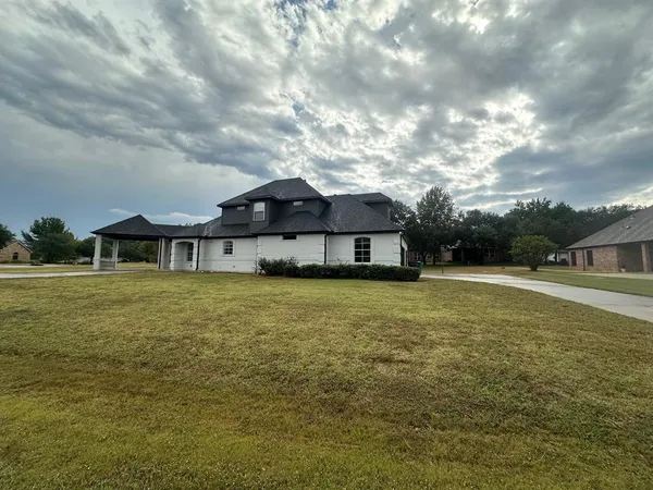 a front view of a house with a big yard