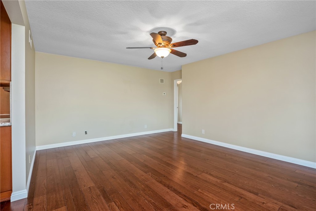 1734 North Vallejo Way Upland, CA 91784 - Photo 11 of 43 an empty room with wooden floor fan and windows