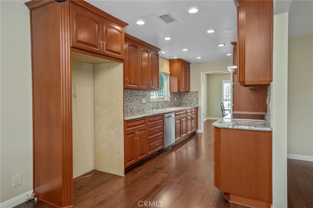 1734 North Vallejo Way Upland, CA 91784 - Photo 14 of 43 a kitchen with stainless steel appliances granite countertop a refrigerator a stove and a wooden floors