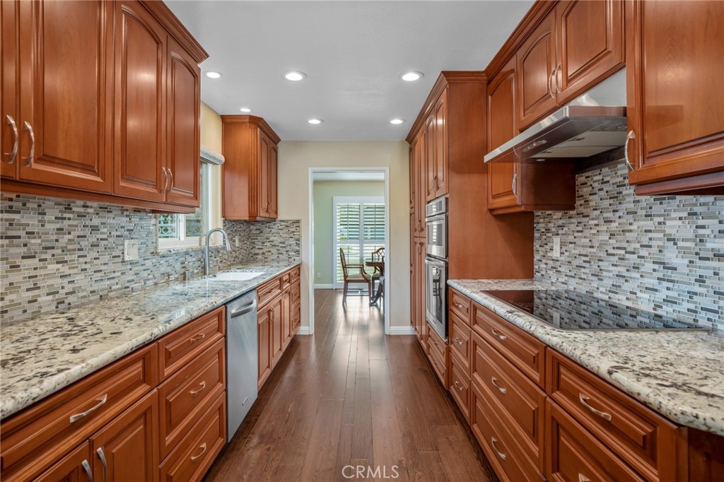 1734 North Vallejo Way Upland, CA 91784 - Photo 15 of 43 a kitchen with stainless steel appliances granite countertop sink stove and cabinets