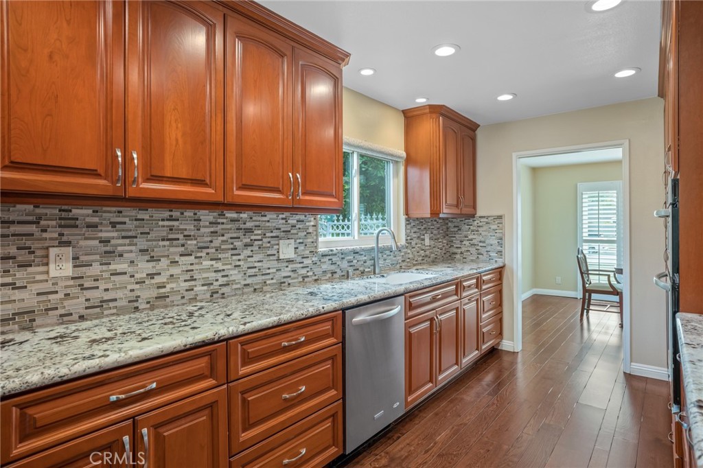 1734 North Vallejo Way Upland, CA 91784 - Photo 16 of 43 a kitchen with stainless steel appliances granite countertop wooden cabinets a sink and dishwasher
