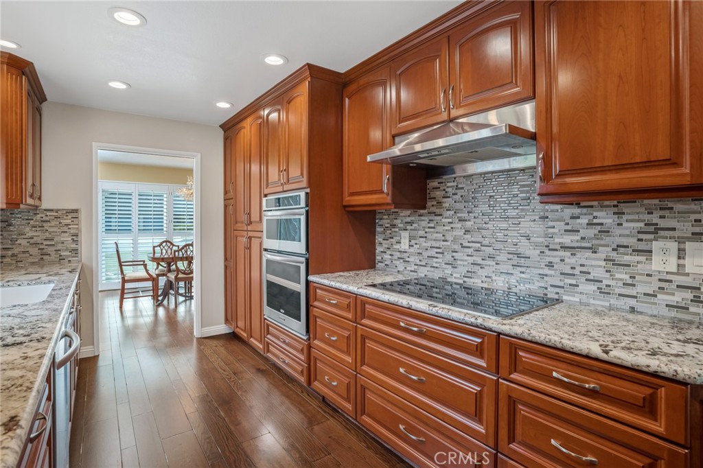 1734 North Vallejo Way Upland, CA 91784 - Photo 17 of 43 a kitchen with stainless steel appliances granite countertop a stove a sink and a microwave