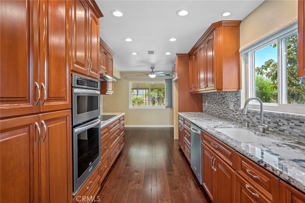 1734 North Vallejo Way Upland, CA 91784 - Photo 18 of 43 a kitchen with stainless steel appliances granite countertop a stove and a sink
