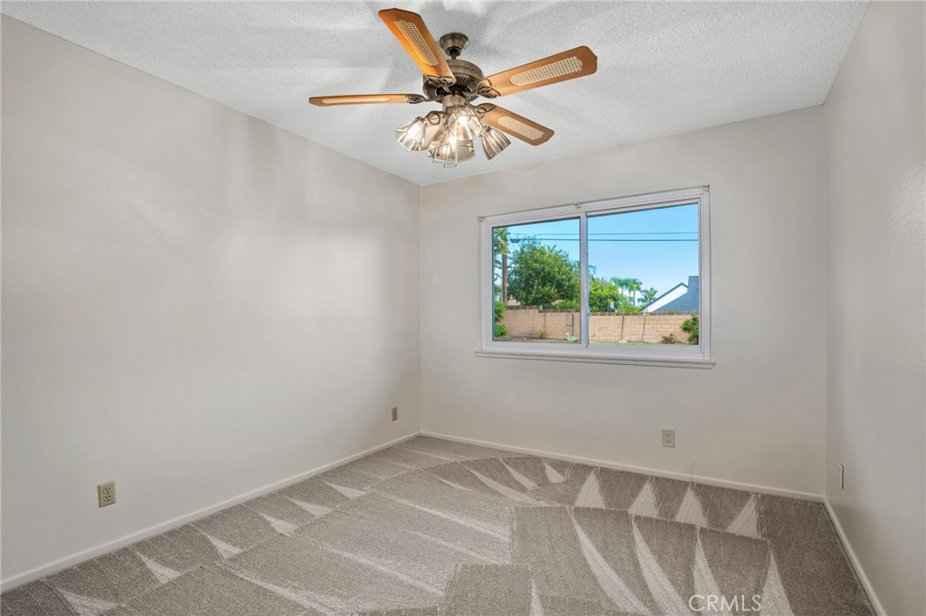 1734 North Vallejo Way Upland, CA 91784 - Photo 29 of 43 an empty room with a window and a ceiling fan