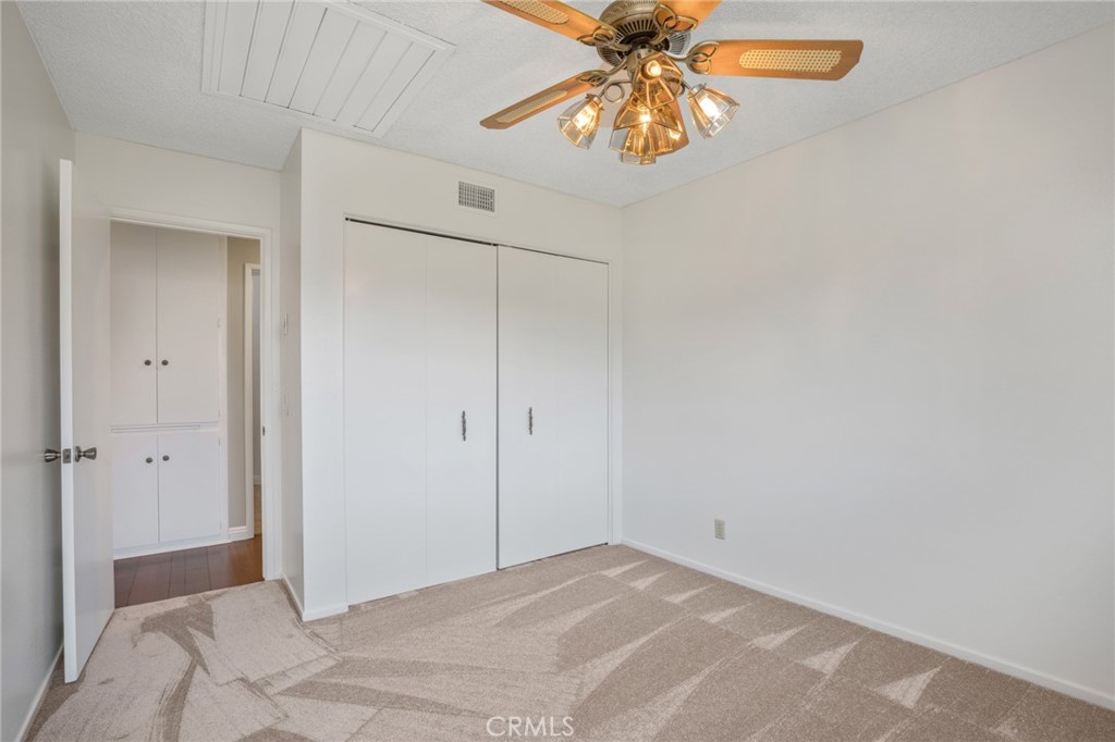 1734 North Vallejo Way Upland, CA 91784 - Photo 30 of 43 a view of a bedroom with a chandelier fan and closet