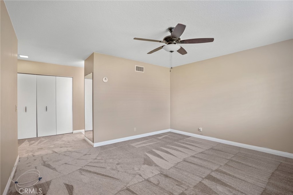 1734 North Vallejo Way Upland, CA 91784 - Photo 32 of 43 a view of a room with wooden floor and a ceiling fan