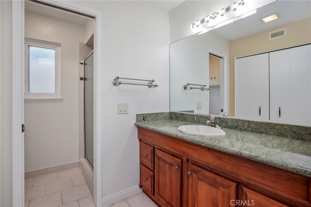 1734 North Vallejo Way Upland, CA 91784 - Photo 35 of 43 a bathroom with a granite countertop sink and a mirror