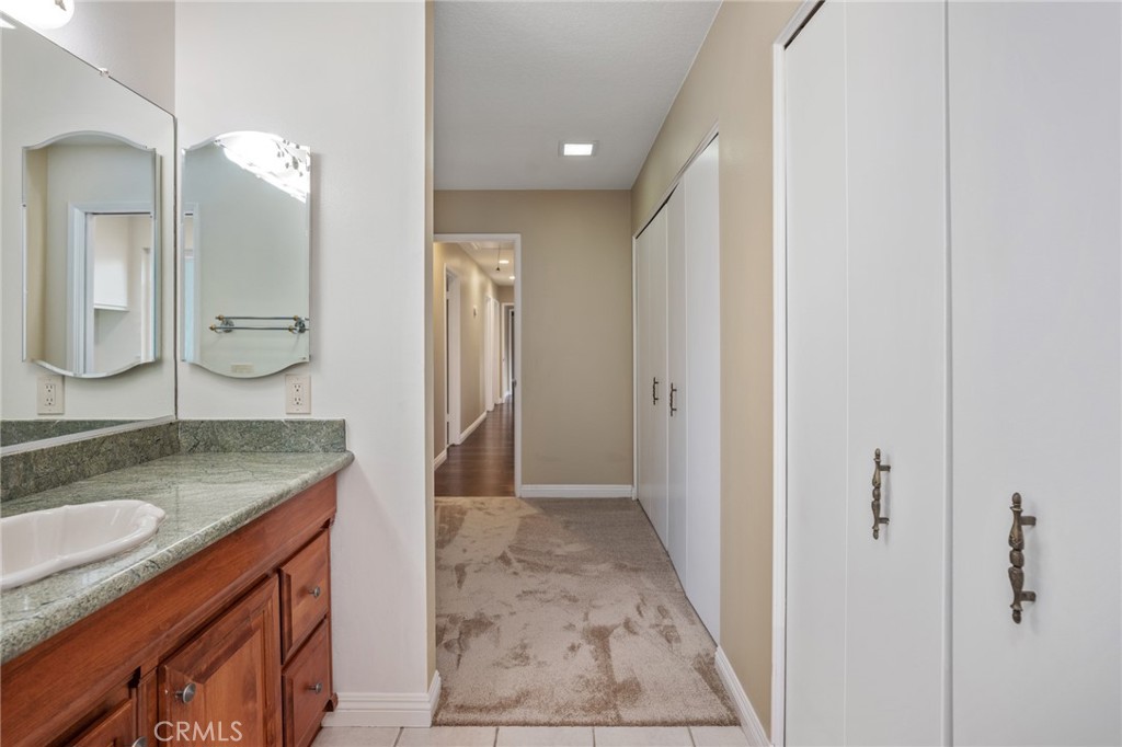 1734 North Vallejo Way Upland, CA 91784 - Photo 36 of 43 a bathroom with a granite countertop sink a mirror and a shower