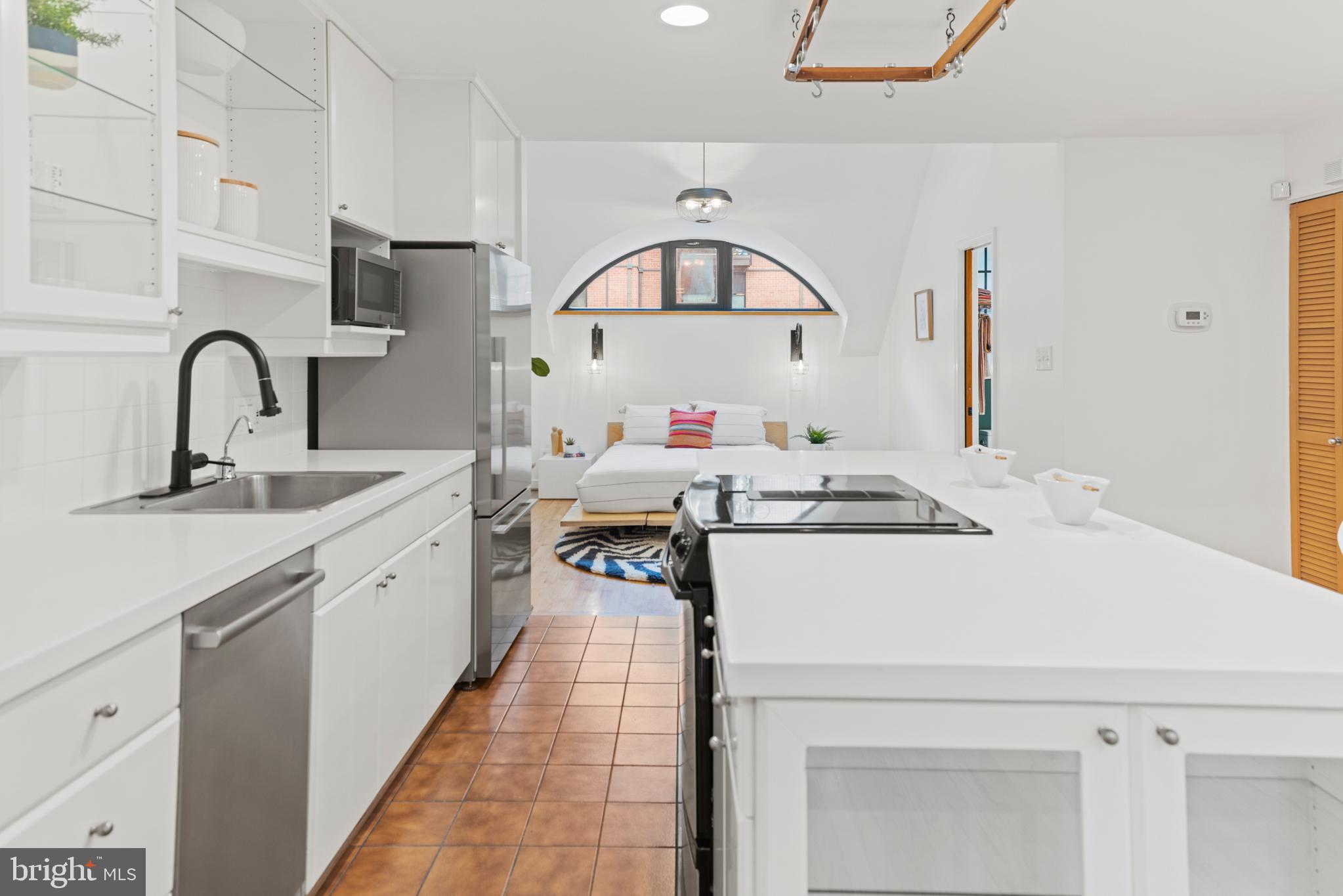 3517 17th Street Northwest, Unit 10 Washington, DC 20010 - Photo 12 of 35 a kitchen with kitchen island a sink appliances and cabinets