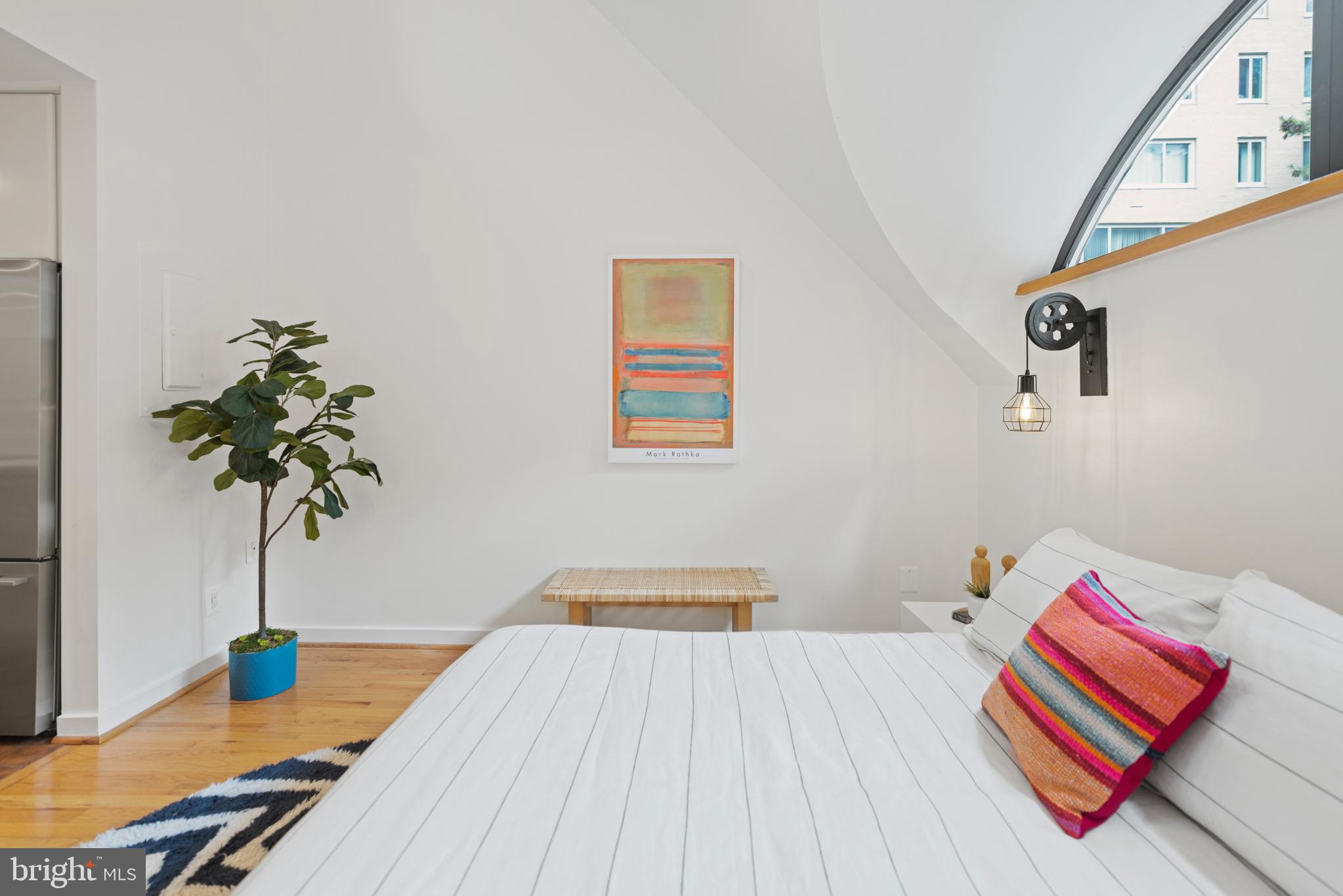 3517 17th Street Northwest, Unit 10 Washington, DC 20010 - Photo 21 of 35 a bedroom with a bed and a potted plant