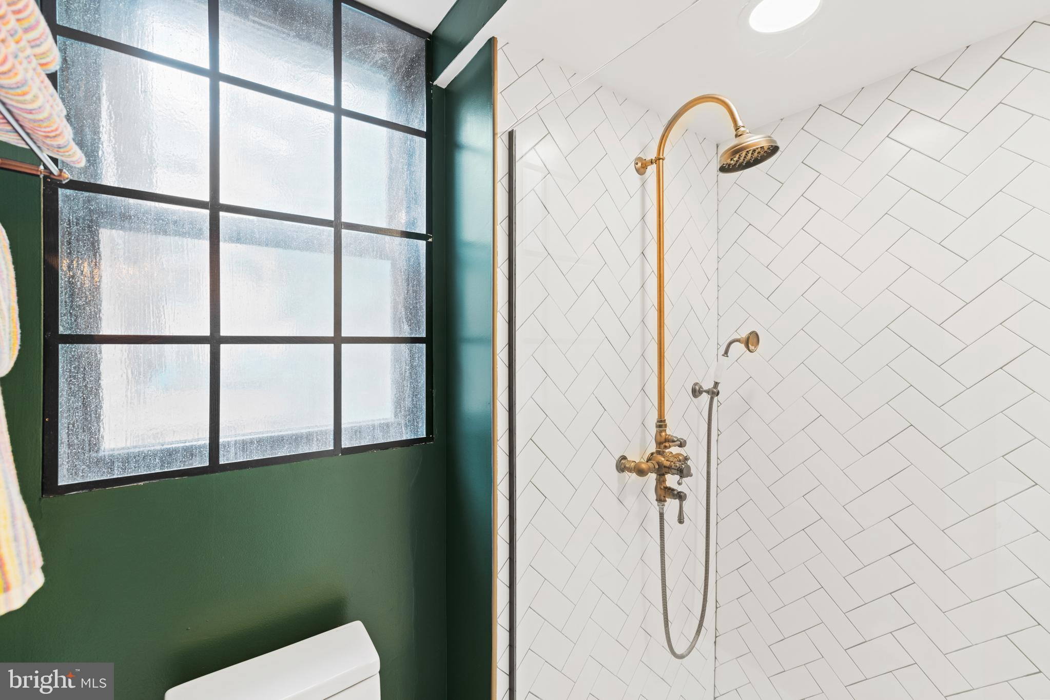 3517 17th Street Northwest, Unit 10 Washington, DC 20010 - Photo 24 of 35 a bathroom with a glass shower door
