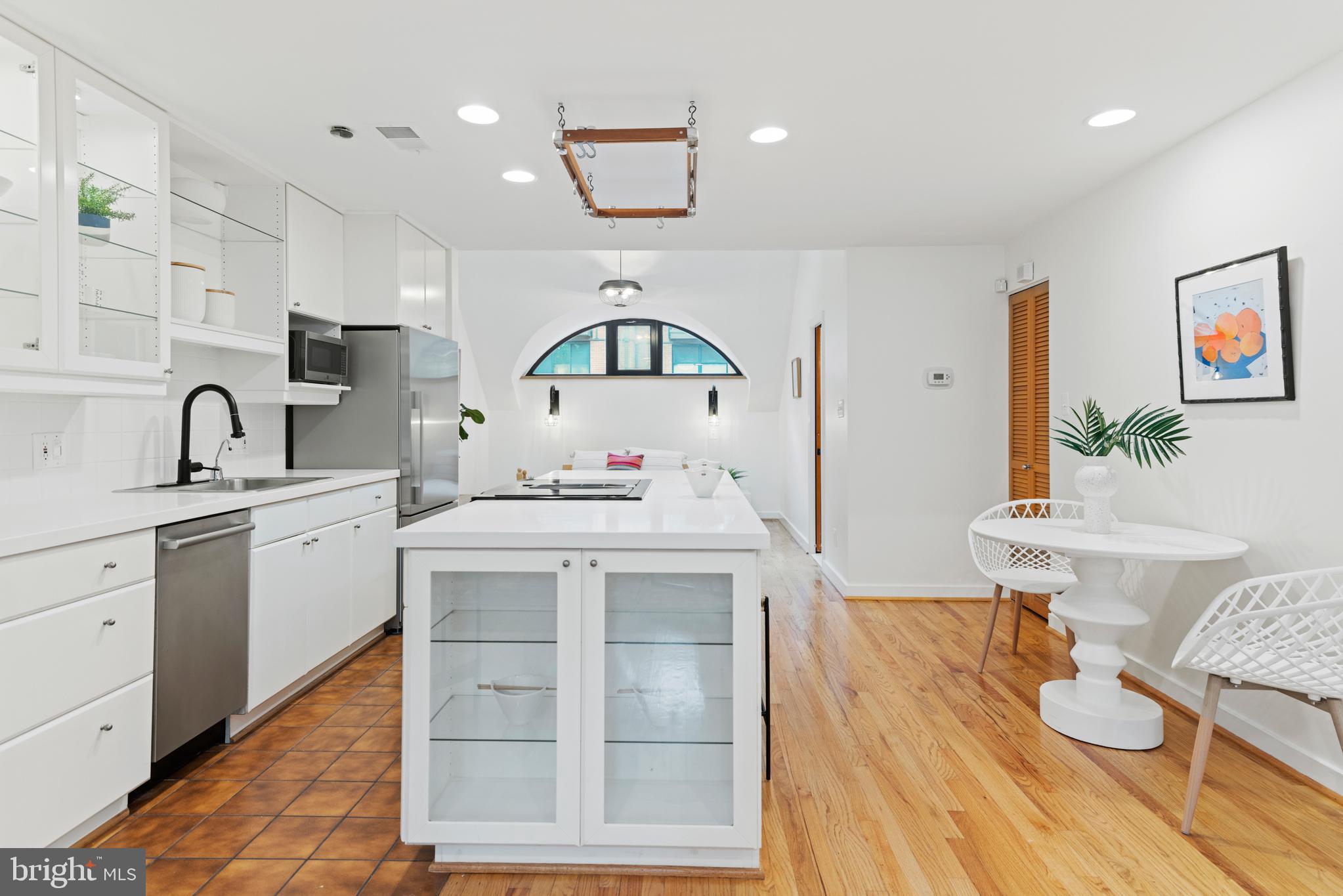 3517 17th Street Northwest, Unit 10 Washington, DC 20010 - Photo 9 of 35 a kitchen with a sink cabinets and wooden floor