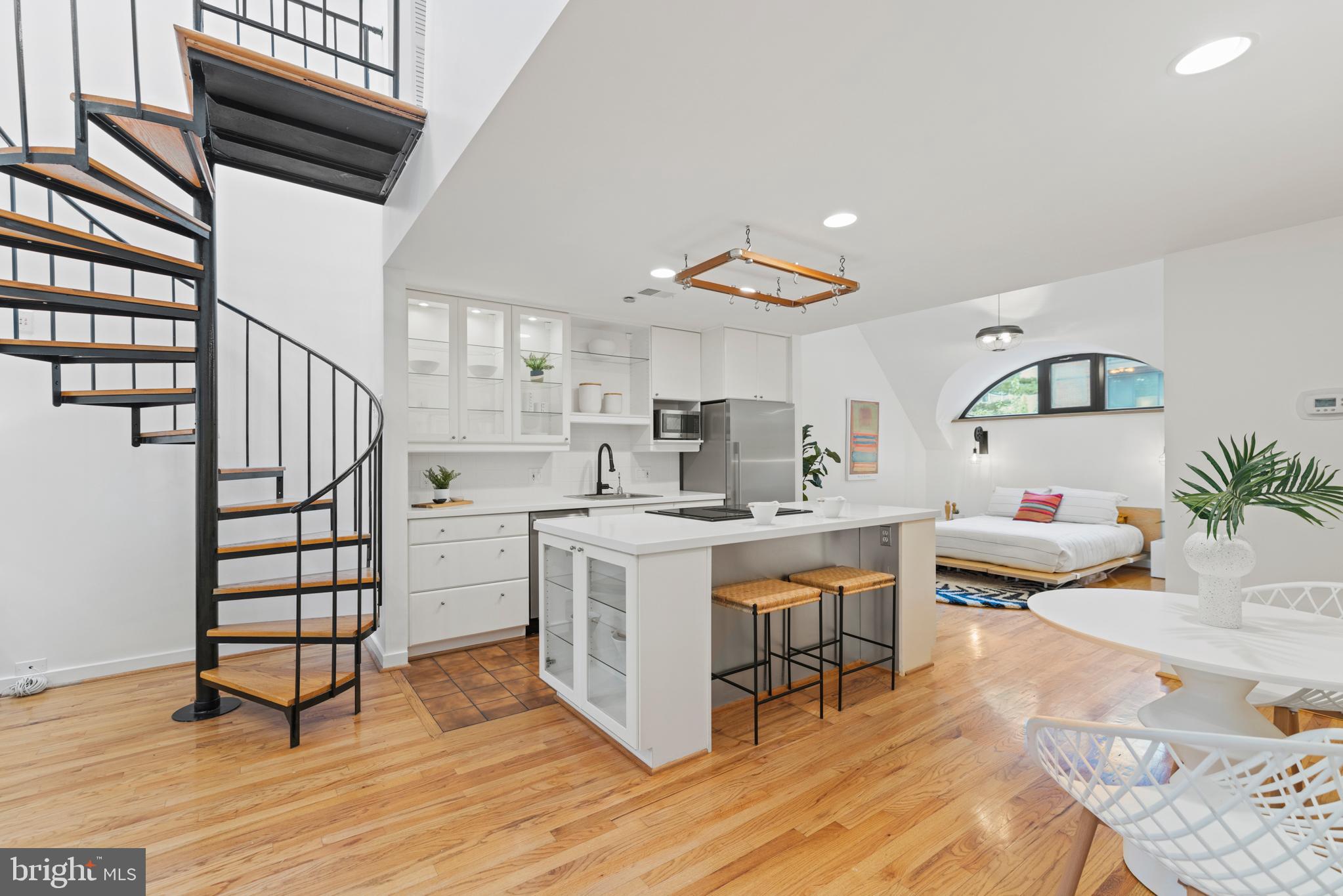 3517 17th Street Northwest, Unit 10 Washington, DC 20010 - Photo 10 of 35 a kitchen with appliances cabinets and wooden floor