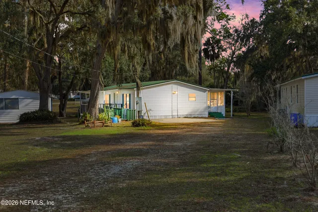 a view of house with backyard