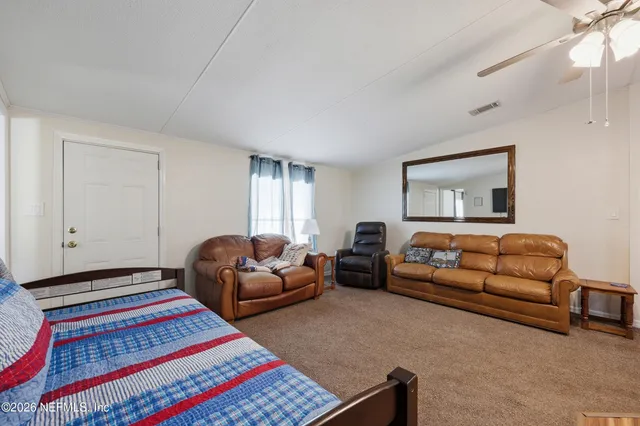 a bedroom with bed and a window