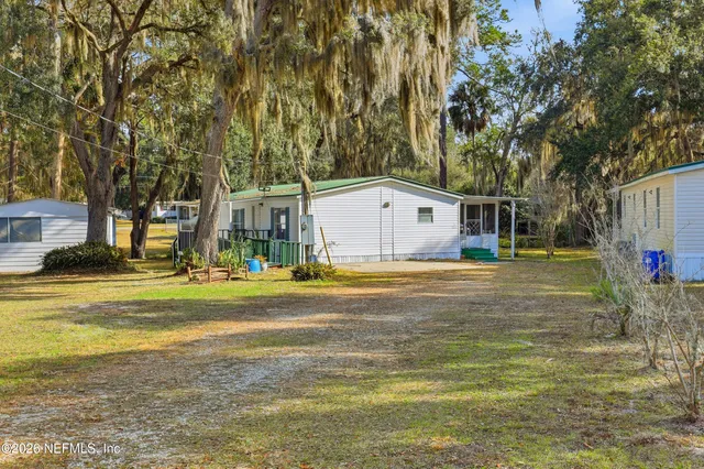 a view of a house with a yard and sitting area