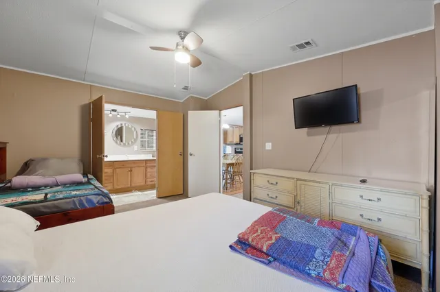 a bedroom with a bed a rug and dresser