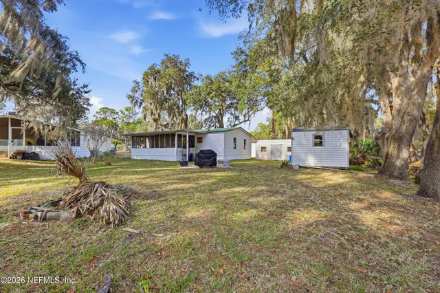 a view of a backyard with large trees
