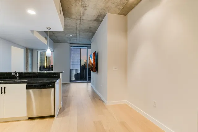 a view of a living room with a sink and a refrigerator
