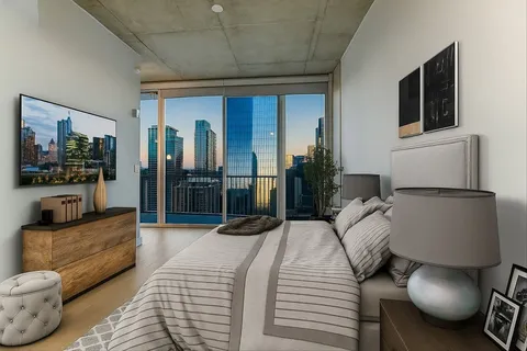 a bedroom with furniture and a flat screen tv