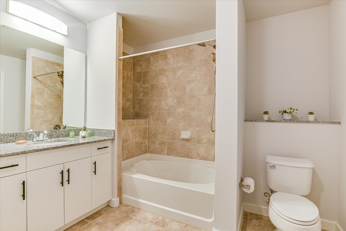 360 Nueces Street, Unit 3207 Austin, TX 78701 - Photo 16 of 30 a bathroom with a granite countertop sink a toilet and shower