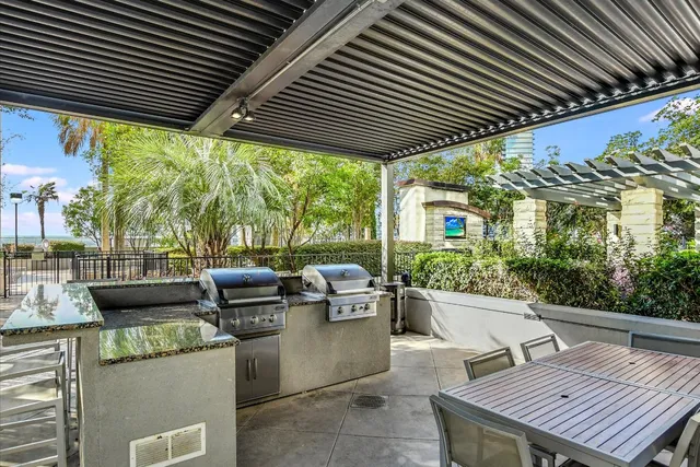 a patio with glass top table and chairs