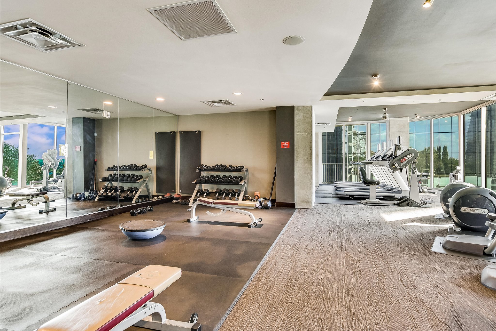 360 Nueces Street, Unit 3207 Austin, TX 78701 - Photo 25 of 30 a view of a room with gym equipment and floor to ceiling window